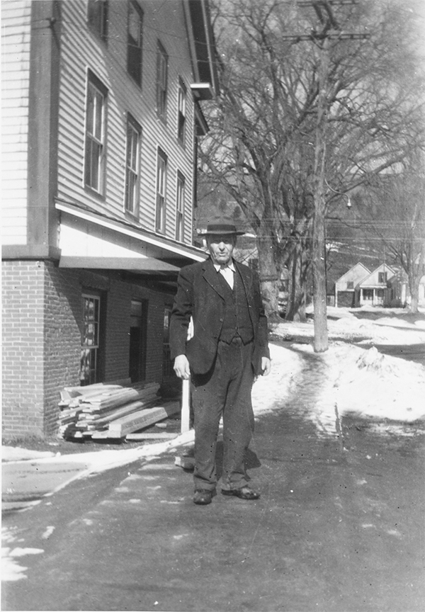 Elmer Mehuron's father-in-law, Dr. Carlos Shaw, the town doctor, is pictured standing down the street from Mehuron's Independent Grocery Store.