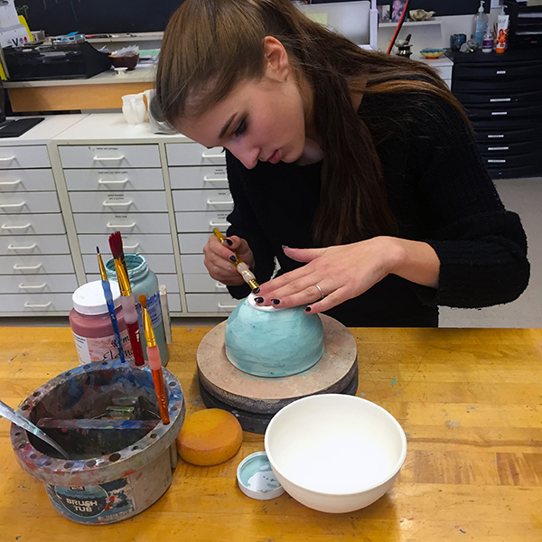 Madison D'Amico, a Harwood student, prepares a bowl for the annual Empty Bowl dinner.