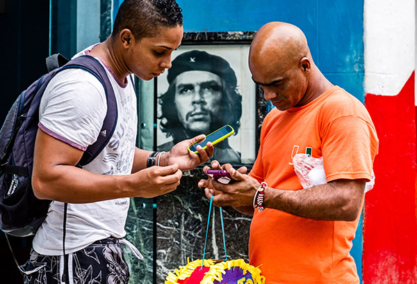 Internet users at a public WiFi hot spot in Central Havana in 2015. Photo: David Garten