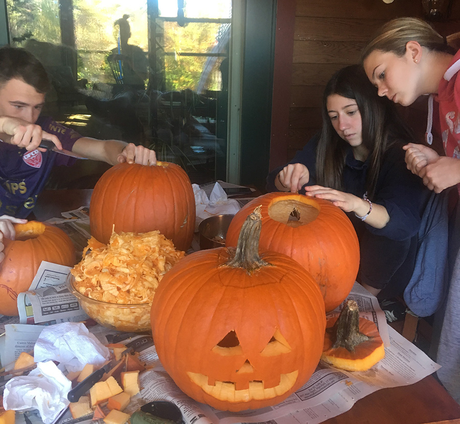 Visiting French students carving pumpkins for Halloween.