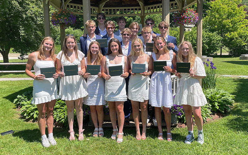 Green Mountain Valley School class of 2022 holding their diplomas.