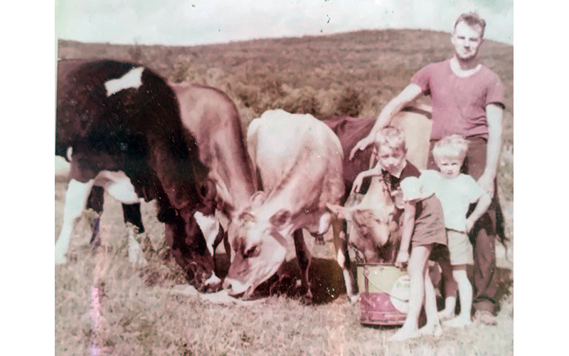 Children Peter Laskowski and Hayden "Dennis" Gaylord (on the right) stand in front of Hadley Gaylord Sr. On the far left is Sophie the Holstein, who Hadley Sr. gave to Peter and helped put him through college. The Jersey cow further right is Elsie the Borden.