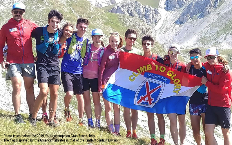 The photo attached was one taken before the 2019 Youth champs on Gran Sasso, Italy. The flag displayed by the American athletes is that of the Tenth Mountain Division. 