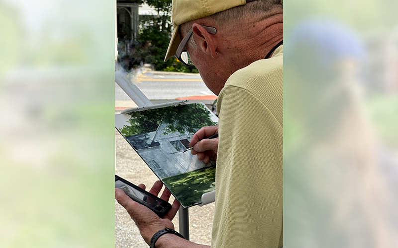 Gary Eckhart puts the finishing touches on his plein air painting in 2023. Photo: Jean Sharry.