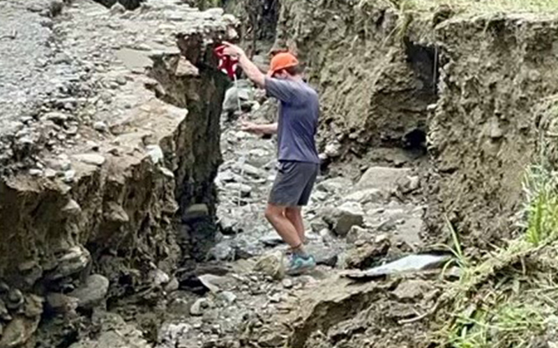 Sam Robinson, community planner, assesses the July 10 flood damages in Fayston, Vermont. Photo courtesy MRVPD/Josh Schwartz 