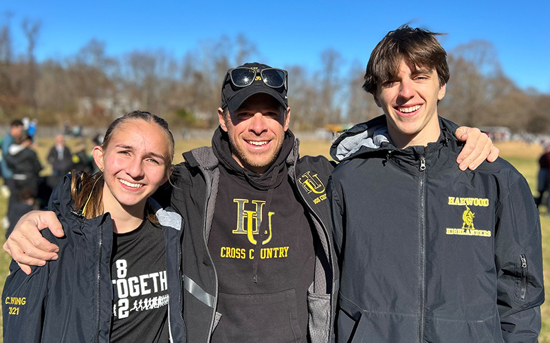 Harwood Cross Country's Celia Wing, coach Matt Migonis, Christopher Cummiskey