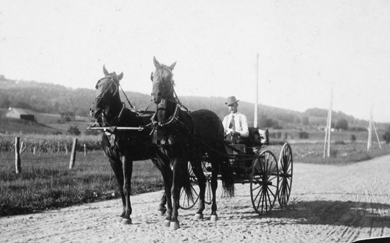 The first Thomas Mehuron in Waitsfield driving his twin horses Jo and Dan Patch on the North Road near his farm.