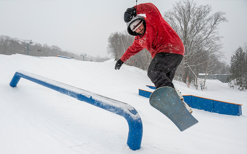 Jackson Krushenick, of Warren slides a rail on his snowboard at Sugarbush’s Mount Ellen, which opened for the season on Friday. Photo by Jeb Wallace-Brodeur.